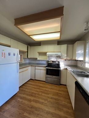 Richmond apartment for rent - an empty kitchen with white cabinets and stainless steel appliances
