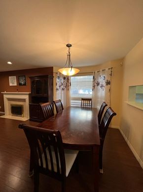 Richmond apartment for rent - a dining room with a wooden table and chairs
