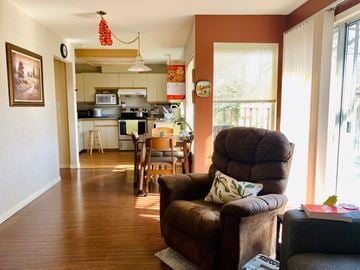 Richmond apartment for rent - a living room with a couch and a chair and a kitchen