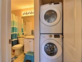 Edmonton apartment for rent - a washer and dryer in a bathroom next to a toilet