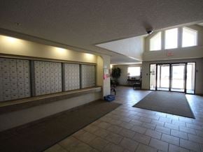 Edmonton apartment for rent - a large hall with a large door and a rug