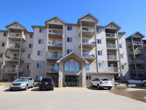 Edmonton apartment for rent - an apartment building with cars parked in front of it