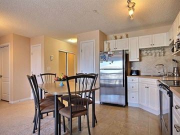 Edmonton apartment for rent - a kitchen with a table and a refrigerator