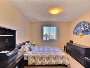 Edmonton apartment for rent - a bedroom with a bed and a television