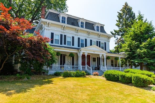Painesville apartment for rent - a large white house with a yard in front of it