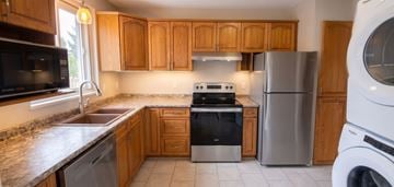 Trenton apartment for rent - A kitchen with wooden cabinets and a stainless steel refrigerator.
