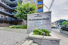 Toronto apartment for rent - The Cottingham Manor Rental Suites sign in front of a building.