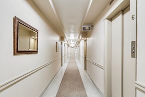 Toronto apartment for rent - A long hallway with doors on both sides and a mirror on the wall.