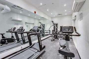 Toronto apartment for rent - A gym with treadmills and exercise equipment.