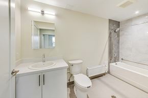 Toronto apartment for rent - A white bathroom with a sink, toilet, and bathtub.