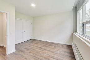 Toronto apartment for rent - A room with a wooden floor and a window on the right side.