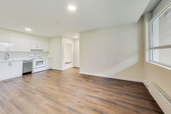 Toronto apartment for rent - A kitchen with white cabinets and a wooden floor.