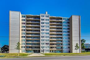 Toronto apartment for rent - A large concrete building with many windows and balconies.