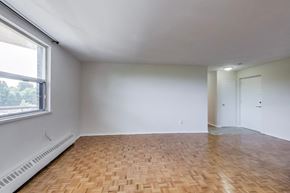 Don Mills apartment for rent - A room with a wooden floor and white walls.