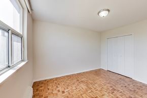 Don Mills apartment for rent - A room with a wooden floor and white walls.