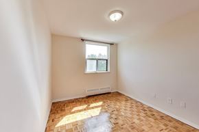 Don Mills apartment for rent - A room with a window and a radiator on the wall.