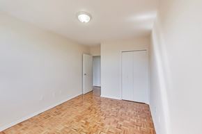 Don Mills apartment for rent - A room with a wooden floor and white walls.