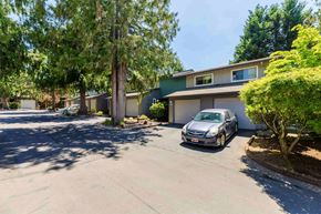 Vancouver apartment for rent - A car is parked in a driveway in front of a house.