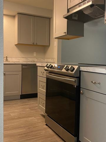 Vancouver apartment for rent - A kitchen with a stove top oven and a dishwasher.