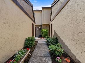 Vancouver apartment for rent - a walkway between two buildings with plants and flowers