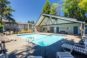 Vancouver apartment for rent - A pool with a diving board and a building in the background.