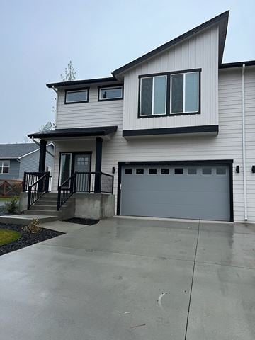 Spokane apartment for rent - a white house with a driveway and a garage door