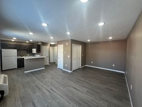 Dodge City apartment for rent - A spacious kitchen with a refrigerator, microwave, and oven.