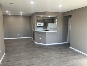 Dodge City apartment for rent - A kitchen area with a refrigerator, microwave, and oven.
