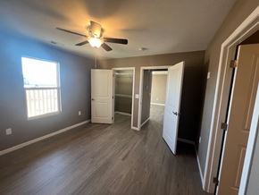 Dodge City apartment for rent - A room with a ceiling fan and three open doors.