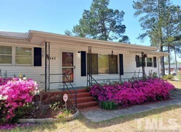 Fayetteville house for rent - a small white house with pink flowers in front of it