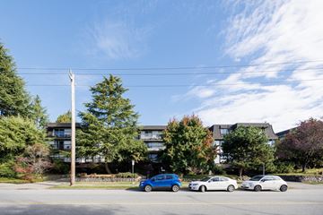 North Vancouver apartment for rent - a city street with cars parked in front of an apartment building
