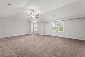 Aiken house for rent - an empty living room with a ceiling fan and a window