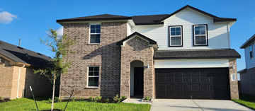 Rosharon house for rent - a brick house with a black garage door
