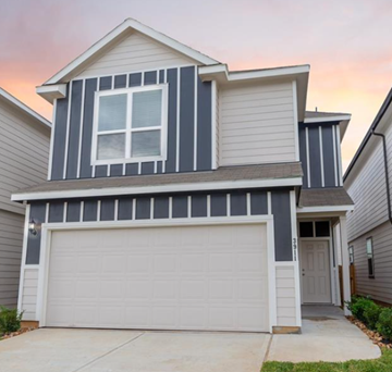 Houston house for rent - A two-story house with a garage door.