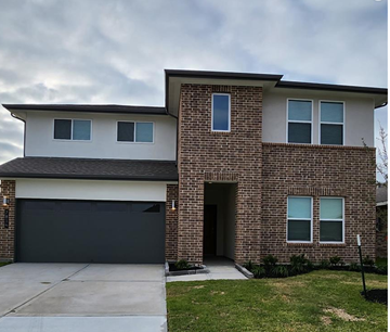 Rosharon house for rent - a brick house with a black garage door