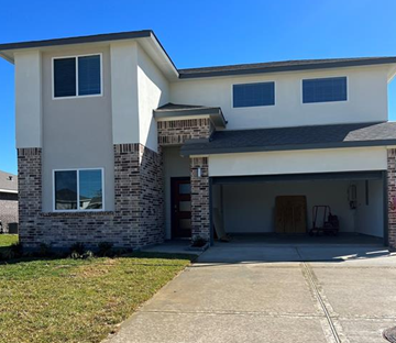 Baytown house for rent - a white house with a driveway and a garage door