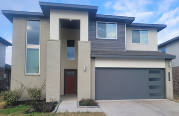 Richmond house for rent - A modern house with a brown door and a grey garage door.