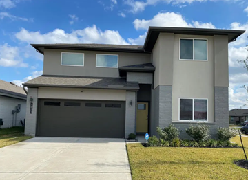 Richmond house for rent - A two-story house with a garage door and a driveway.