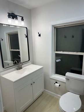 Bristol house for rent - a white bathroom with a toilet and a sink and a window