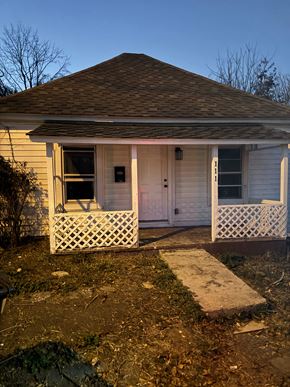 Bristol house for rent - a small yellow house with a porch and a white door