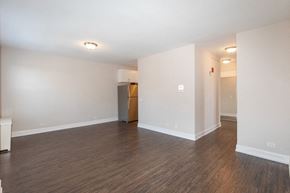 Chicago apartment for rent - an empty living room with wood flooring and white walls