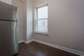 Chicago apartment for rent - an empty room with a refrigerator and a window