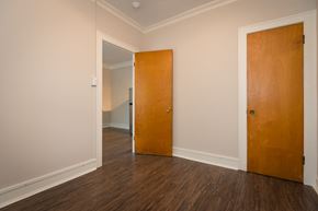 Chicago apartment for rent - an empty room with a wooden floor and a wooden door