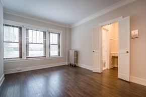 Chicago apartment for rent - an empty living room with wood flooring and windows