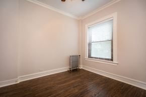 Chicago apartment for rent - an empty room with a radiator and a window