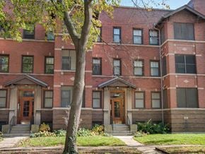 Chicago apartment for rent - a red brick building with a tree in front of it