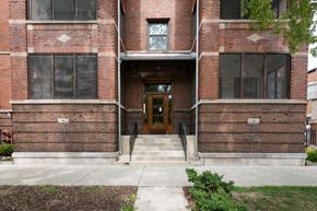 Chicago apartment for rent - the front of a brick building with a wooden door
