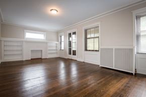 Chicago apartment for rent - the living room of an empty house with wood floors and a fireplace