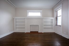 Chicago apartment for rent - a living room with a fireplace and white shelves