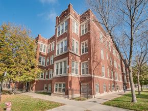 Chicago apartment for rent - a red brick building with a sidewalk in front of it